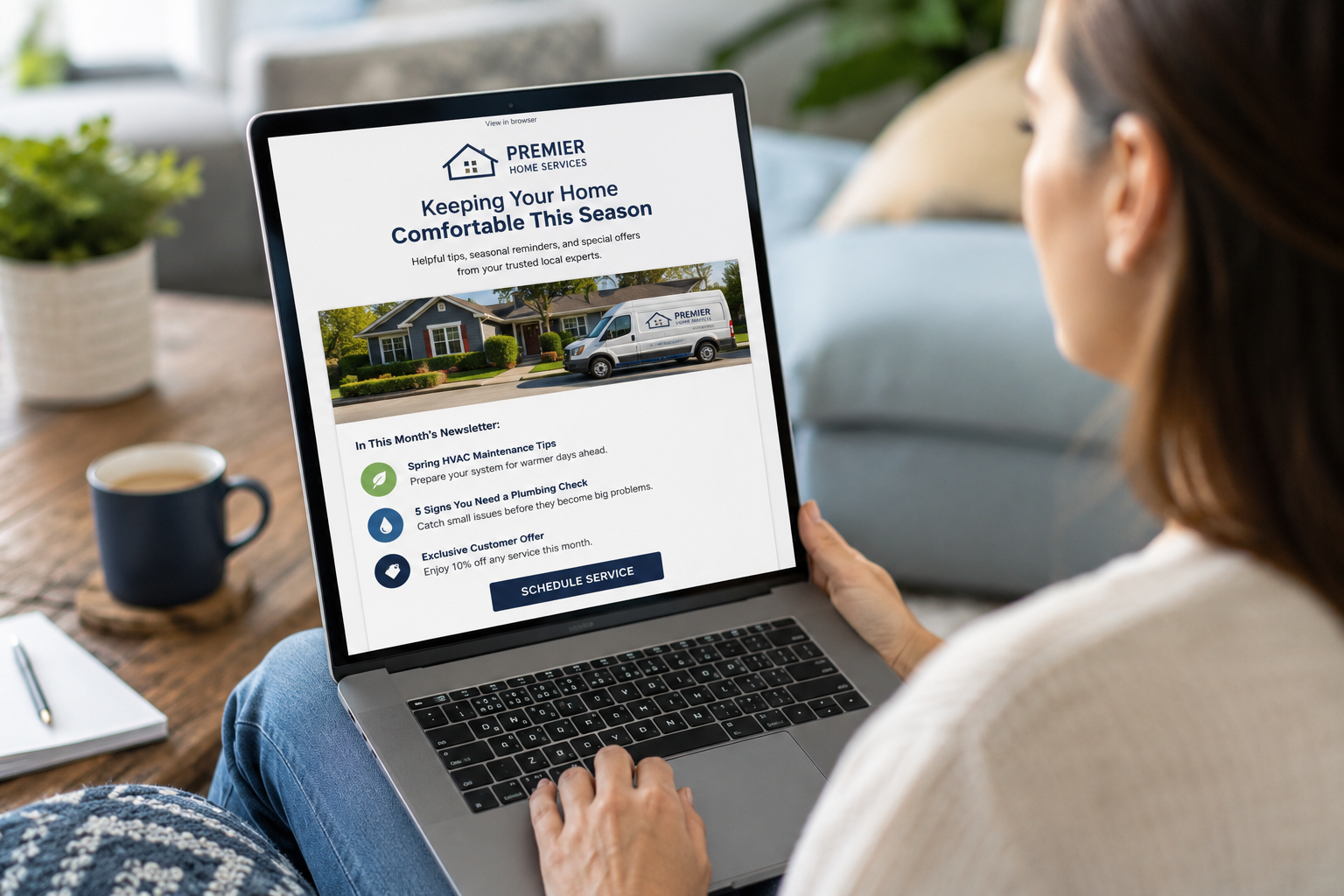 Homeowner reading a contractor email newsletter featuring seasonal maintenance tips and home improvement recommendations.
